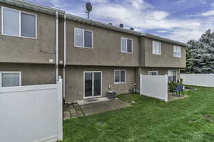 Rear view of property with a patio and stucco siding