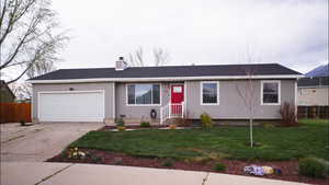 Ranch-style house featuring a chimney, concrete driveway, a garage, and roof with shingles