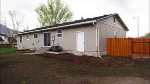 Back of house featuring entry steps and a gate