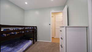 Bedroom featuring light carpet and recessed lighting