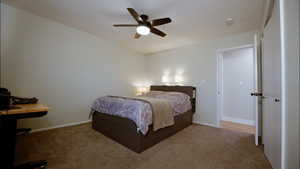 Carpeted bedroom with baseboards and ceiling fan