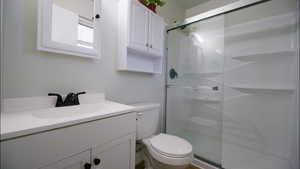 Bathroom with vanity and a stall shower