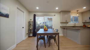 Dining area featuring light wood-type flooring, recessed lighting, and healthy amount of natural light