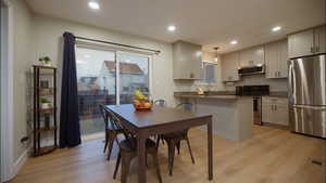 Dining room featuring light wood-style floors and recessed lighting