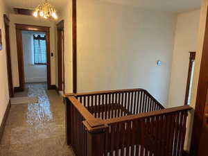 Hall with a chandelier and an upstairs landing