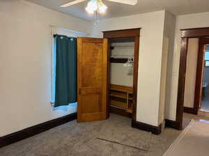 Unfurnished bedroom with carpet, a closet, and ceiling fan