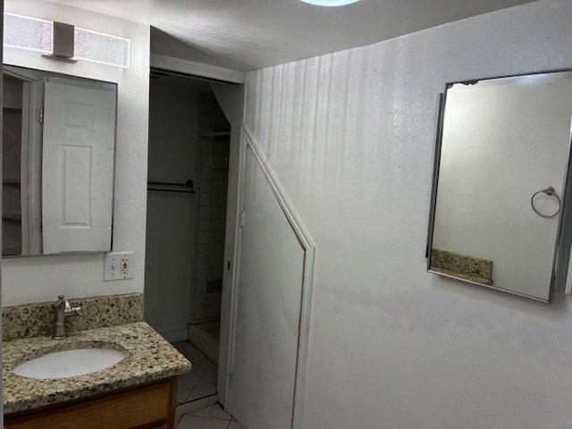 Full bathroom featuring vanity and light tile patterned floors