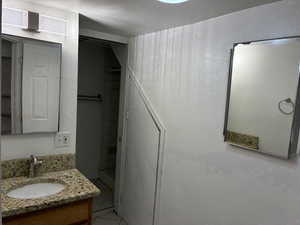 Full bathroom featuring vanity and light tile patterned floors