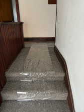 Staircase featuring baseboards