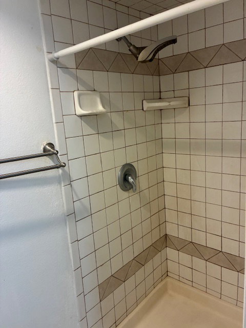 Full bathroom featuring a shower stall