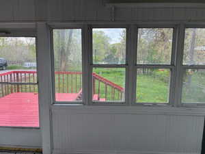 Doorway to outside with wood walls