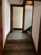 Staircase featuring baseboards and carpet floors