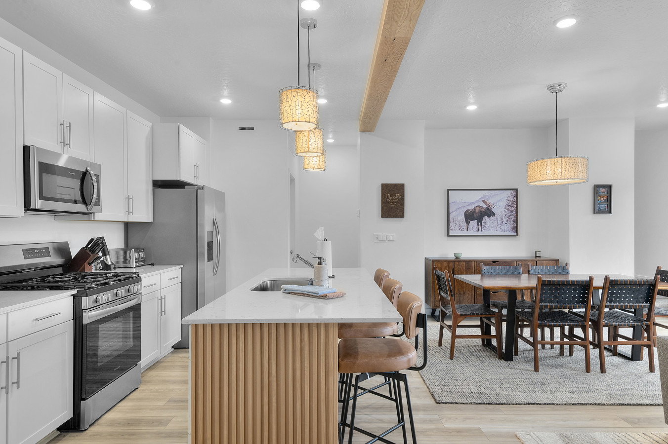 Open concept living with great space to gather! Fluted paneling and beam accents.