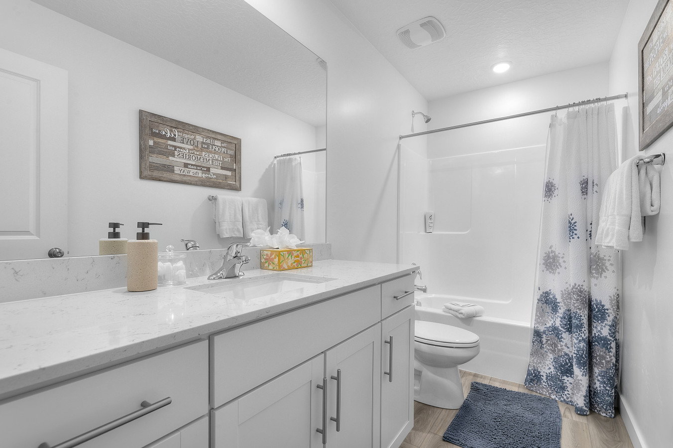Main bath offering a tub and shower combination with large vanity and beautiful cabinetry.