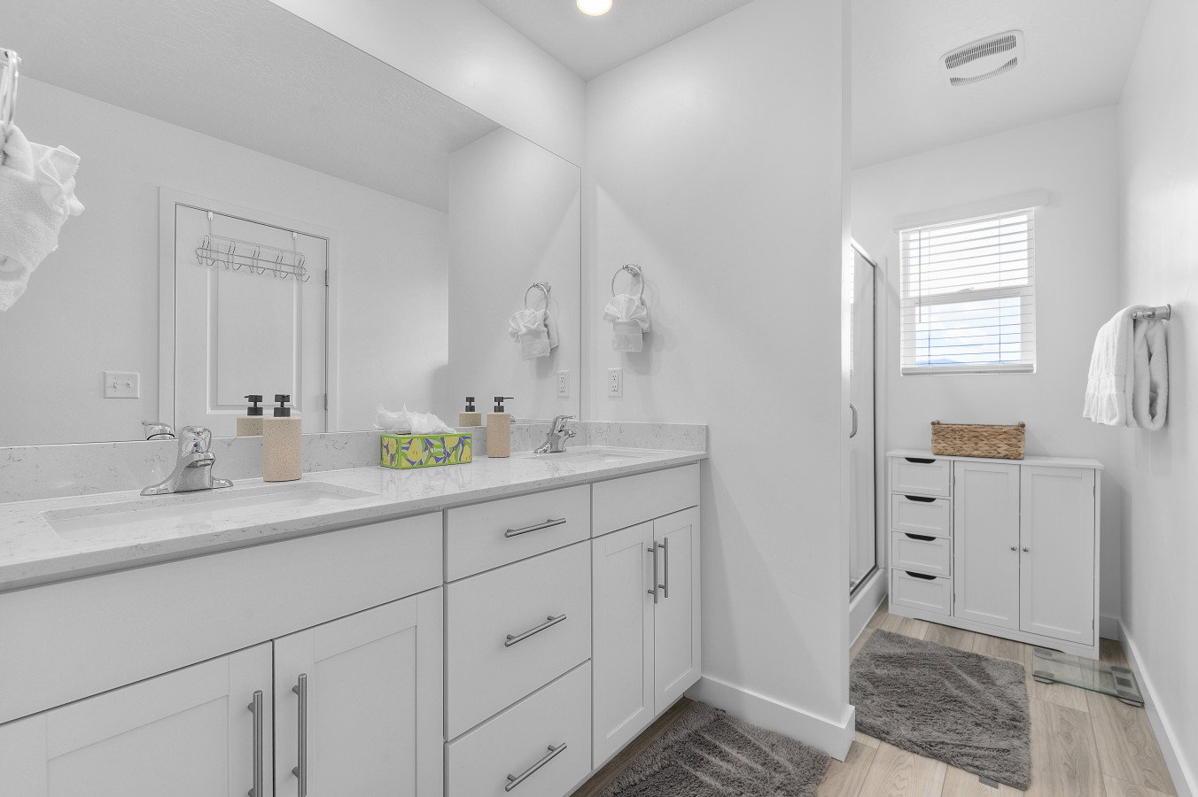 Primary bath featuring dual vanity and walk in shower. Spacious, light and bright.