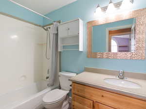 Full bathroom featuring vanity and shower / bath combo with shower curtain