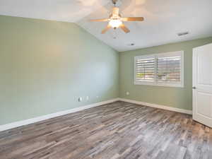 Unfurnished room featuring ceiling fan and dark wood-style floors