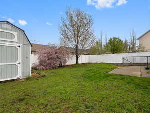 Fenced backyard with a storage shed