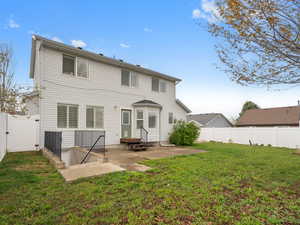 Rear view of property with a patio area, a fenced backyard, a gate, and entry steps
