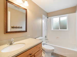 Bathroom with vanity and bathing tub / shower combination