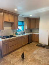 Kitchen featuring tile counters, recessed lighting, wood finish cabinets, tasteful backsplash, and light tile patterned floors