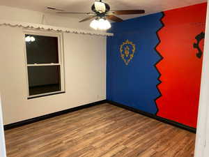 Spare room with ceiling fan and wood finished floors
