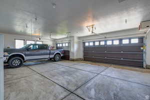 Garage with baseboards and a heating unit