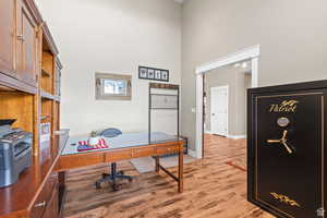 Office space with a high ceiling and light wood-style floors