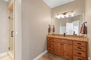 Full bath with vanity and a shower stall