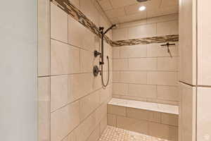 Bathroom featuring a shower stall and recessed lighting