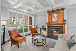Sitting room with a fireplace, coffered ceiling, ornamental molding, and recessed lighting