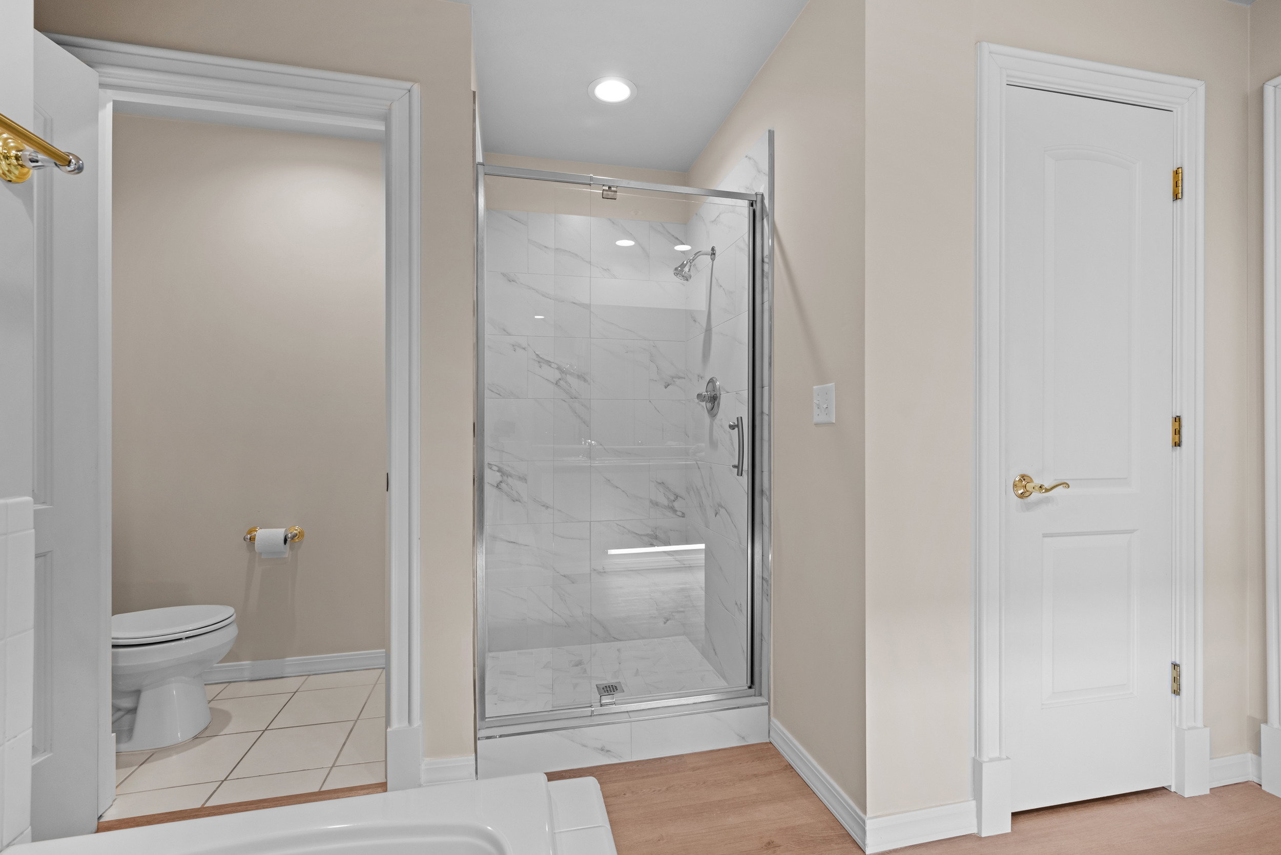 Bathroom featuring a marble finish shower and recessed lighting
