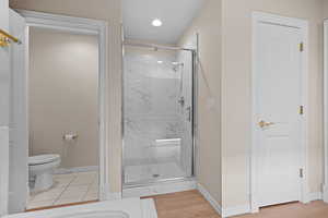 Bathroom featuring a marble finish shower and recessed lighting