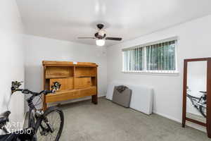 Miscellaneous room featuring light carpet and ceiling fan
