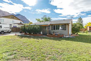 View of front facade with a patio and a mountain view