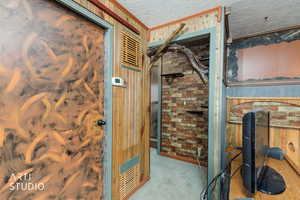 Detailed view of wooden walls, a textured ceiling, and carpet