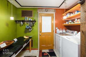 Laundry area with washing machine and clothes dryer and light floors