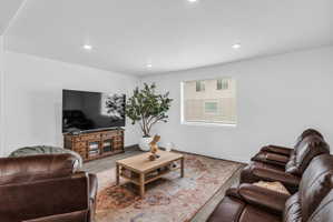 Living area with wood finished floors and recessed lighting