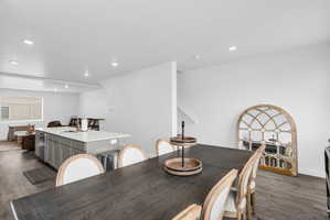 Dining space featuring dark wood-type flooring and recessed lighting