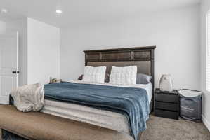 Bedroom with carpet flooring and multiple windows