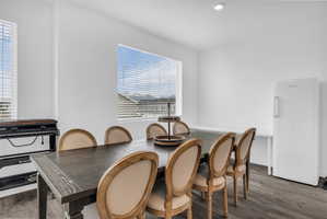 Dining area featuring wood finished floors and recessed lighting
