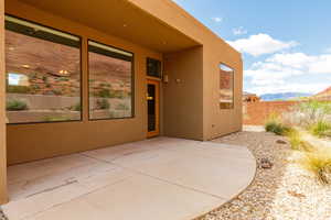 Doorway to property with a patio area, a mountain view, and stucco siding