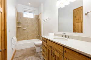 Full bath with vanity, shower / bathtub combination, and light tile patterned flooring