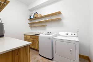 Laundry area with independent washer and dryer and concrete floors