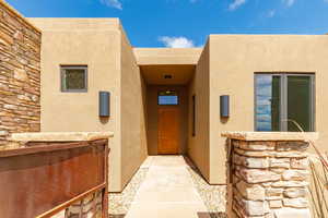 View of exterior entry with stucco siding