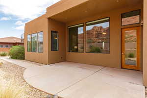 Property entrance featuring a patio and stucco siding