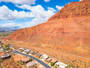 Aerial view of sparsely populated area with a mountain backdrop and nearby suburban area