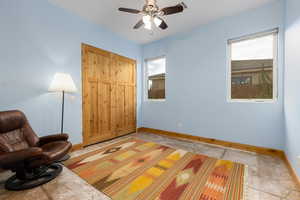 Unfurnished room featuring baseboards and a ceiling fan