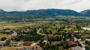 Aerial view of residential area with a water and mountain view and a local golf course