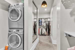 Spacious walk-in closet designed for both organization and convenience, featuring ample storage and a dedicated in-closet washer and dryer—bringing everyday functionality to a new level of luxury.